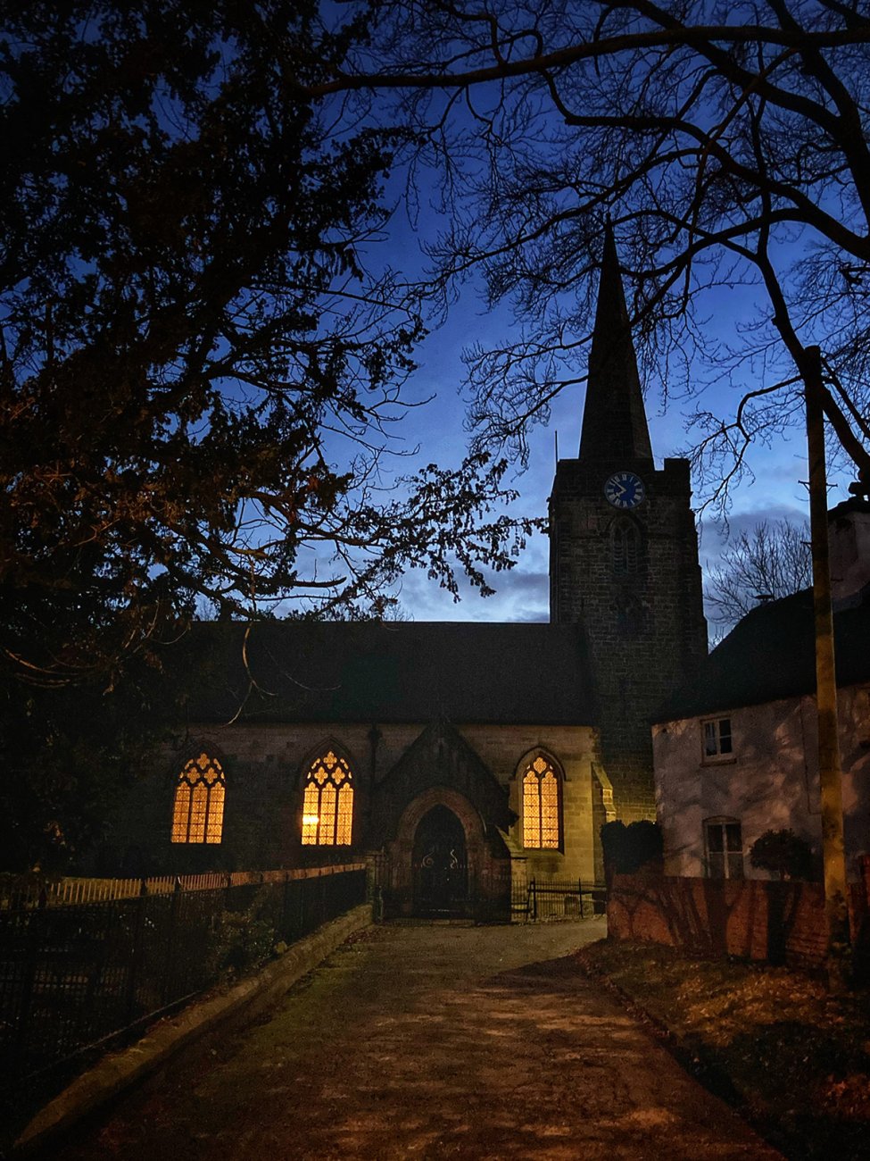 Photograph of Welcoming lights in the evening from St Werburgh's